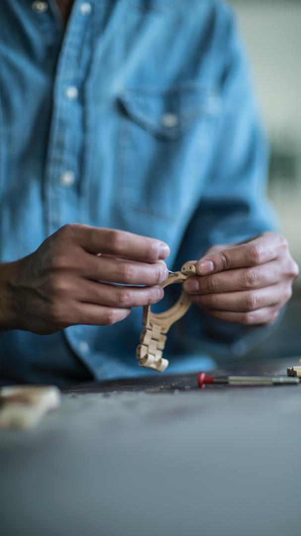 Artisan woodworker handcrafting wooden desk accessories - traditional craftsmanship and quality
