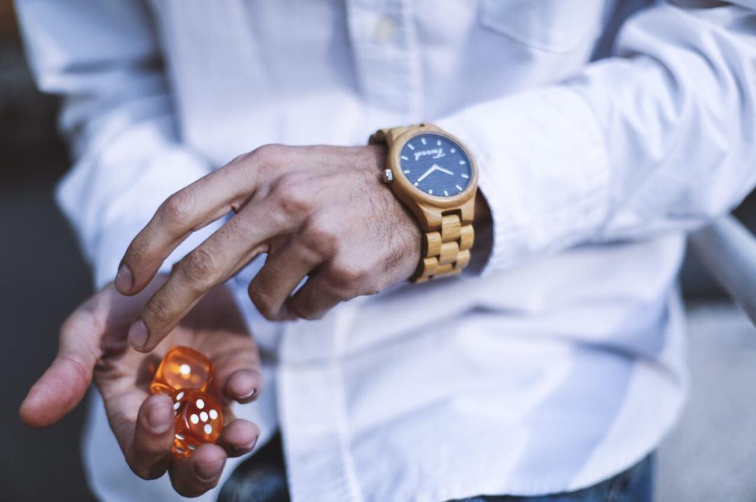 Handcrafted wooden watch care guide - cleaning natural wood timepiece with soft cloth