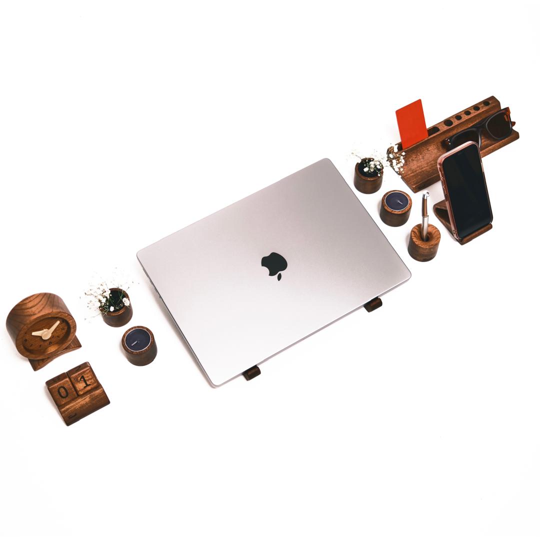 Beautiful organized workspace with wooden desk accessories - laptop stand, organizer, phone holder and clock