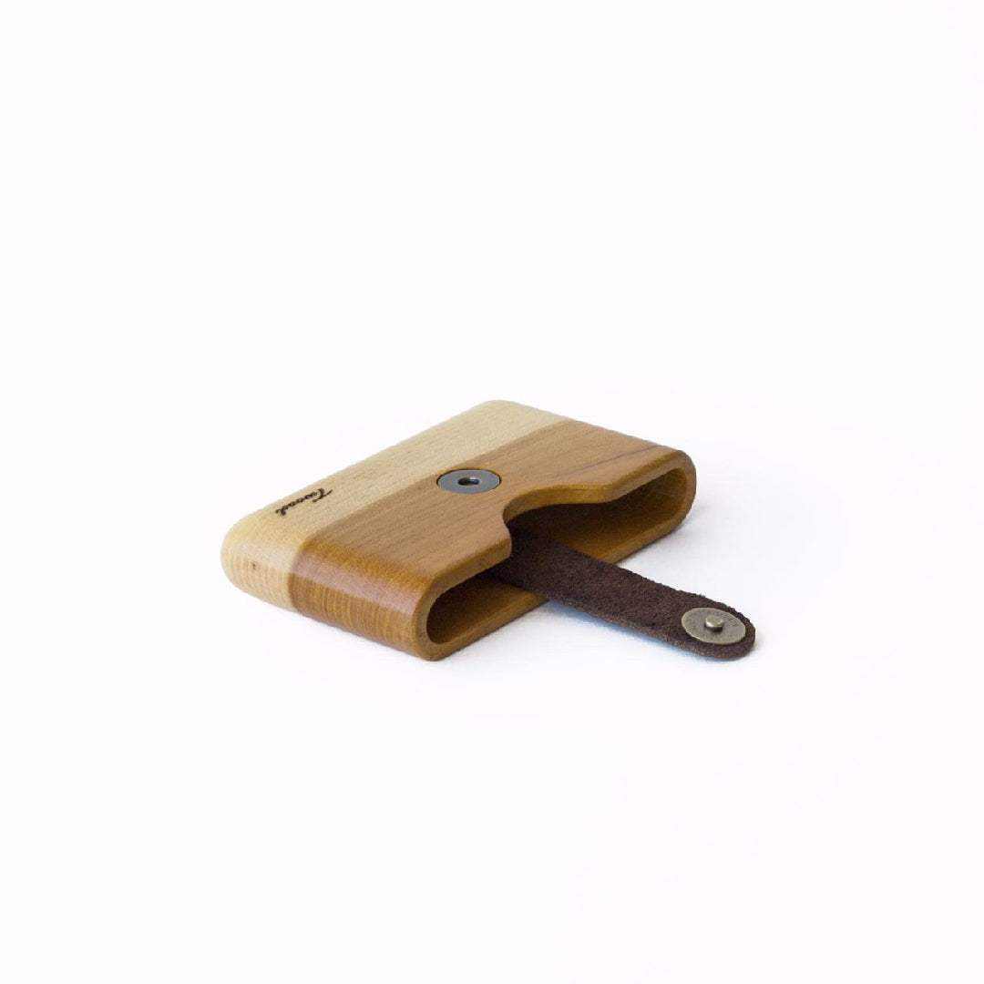 Minimalist handmade wooden wallet with card slot and leather strap, eco-friendly and sustainable design.