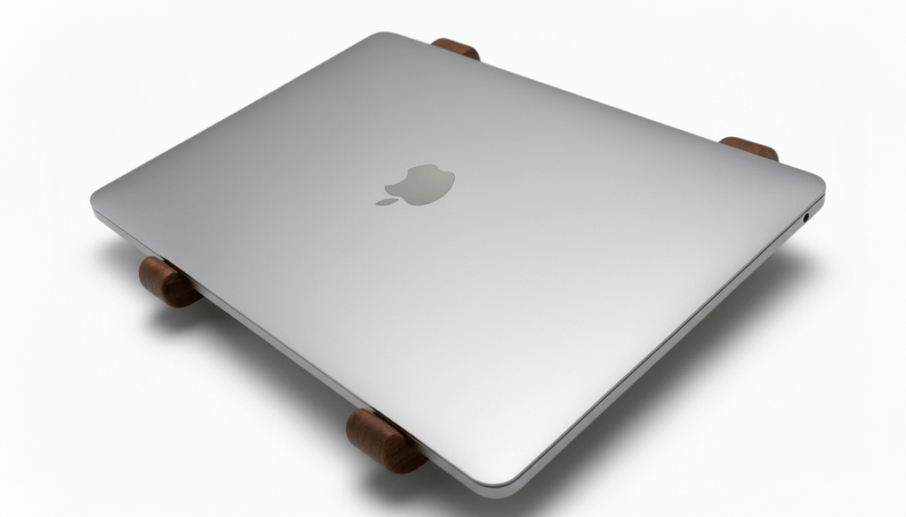 Silver laptop on a wooden stand with Apple logo