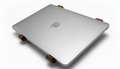 Silver laptop on a wooden stand with Apple logo