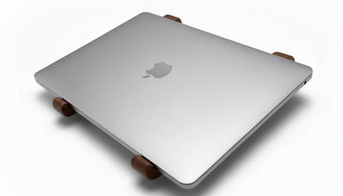 Silver laptop on a wooden stand with Apple logo