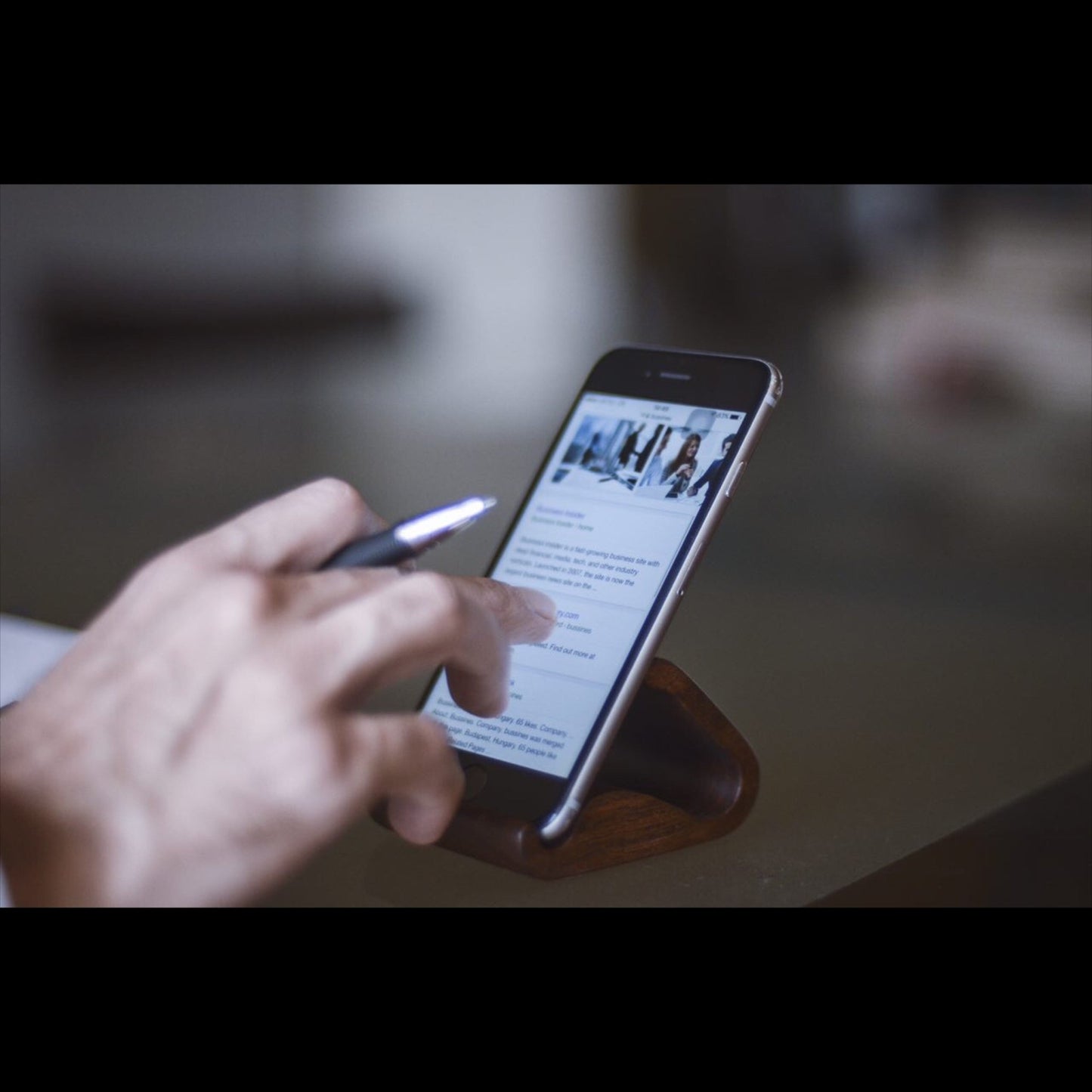 Wooden mobile stand close-up - handmade natural wood phone holder detail