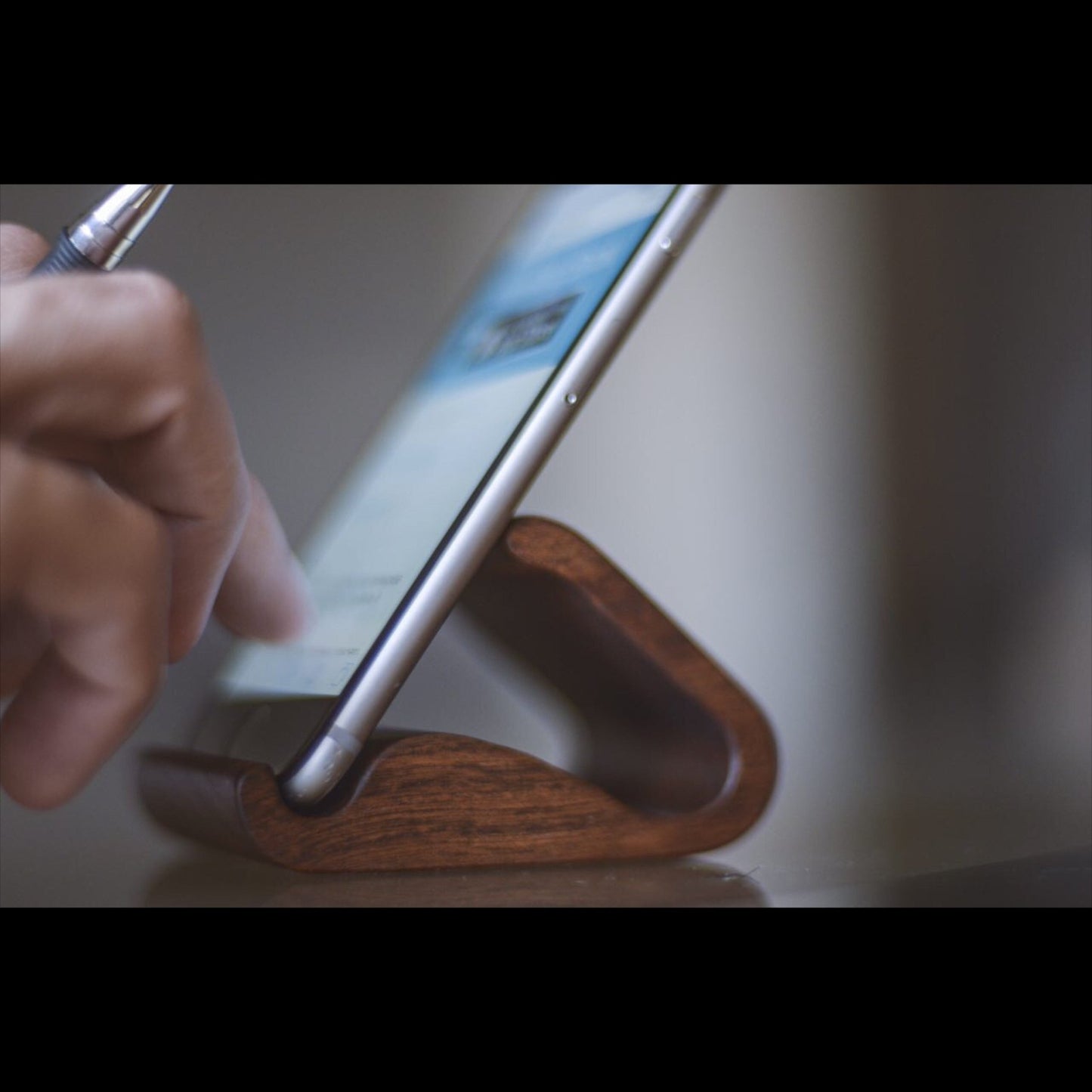 Wooden phone stand with smartphone - handmade natural wood mobile holder in use